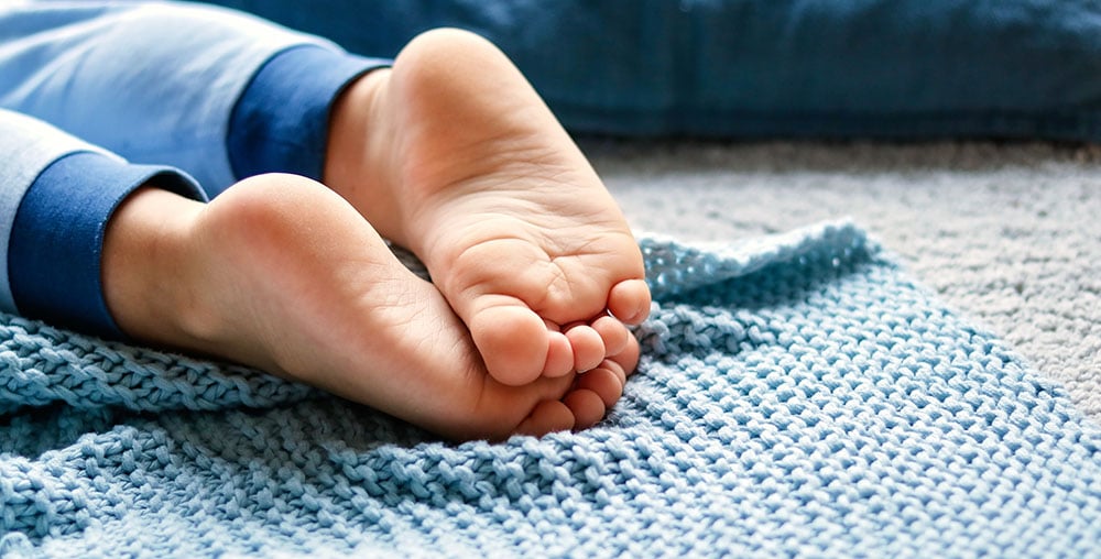 Cozy holidays at home. Close up photo of little child barefooted Cozy holidays at home. Close up photo of little child barefooted